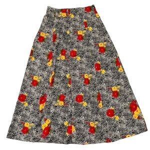 Vintage women’s full flowy black and beige midi skirt with bright floral pattern